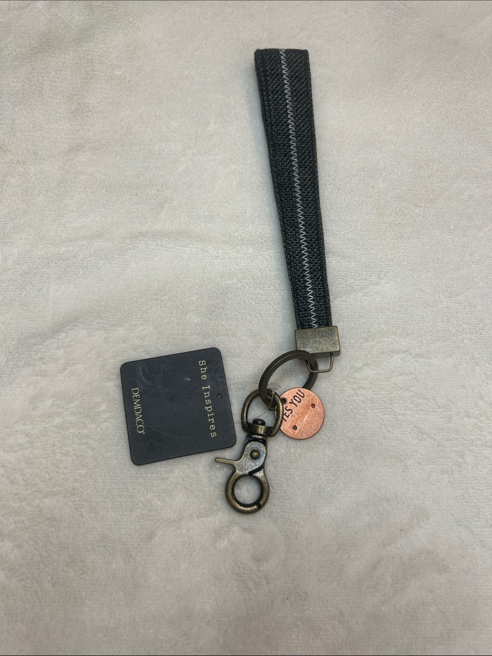 Demdaco Black Wrist Strap Keychain with Copper Token